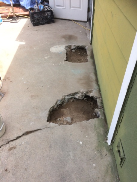 These holes had to be jackhammered in the concrete, just to prove there was dirt underneath. Actually no, they wanted to see the foundation next to the house.